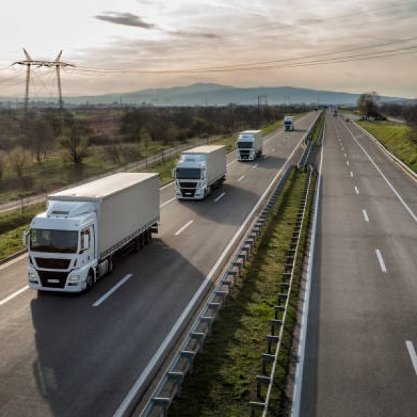 Caravan or convoy of trucks in line on a country highway